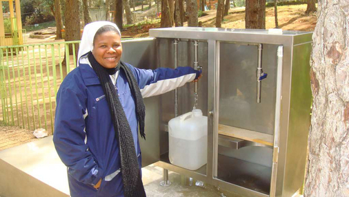 Die Leiterin des Kinderdorfes, Schwester Bonite, freut sich über sauberes Trinkwasser. © nph