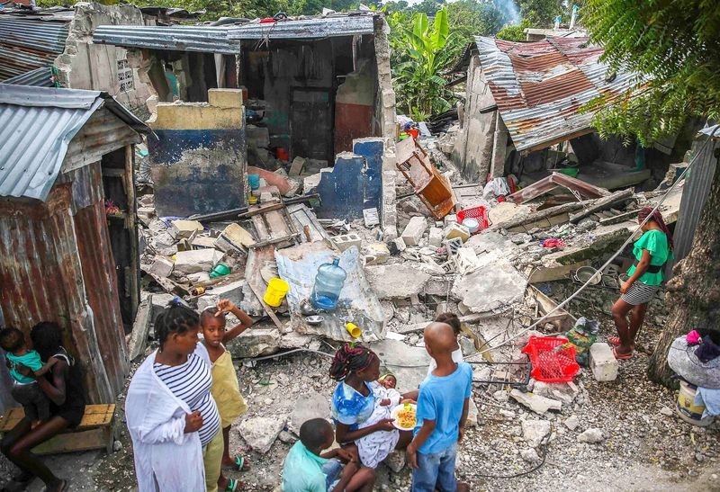 Eine Familie frühstückt am Morgen nach dem Erdbeben in den Ruinen ihres Hauses.
